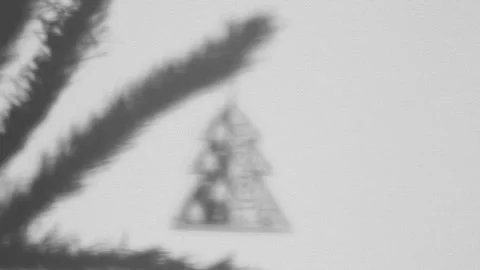 Puppet Shadow Theatre. A hand hangs a Christmas tree toy from a tree branch Stock Footage 165397063