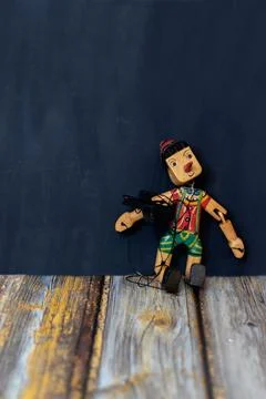 A puppet sitting on the wood Stock Photos