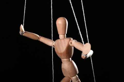 Puppet with strings on black background Stock Photos