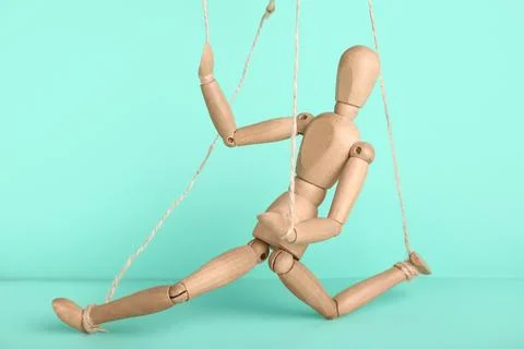 Puppet with strings on turquoise background Stock Photos