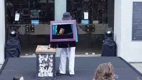 Puppeteer Performing with Puppet for a Small Crowd at an Art Festival 스톡 동영상 337196180