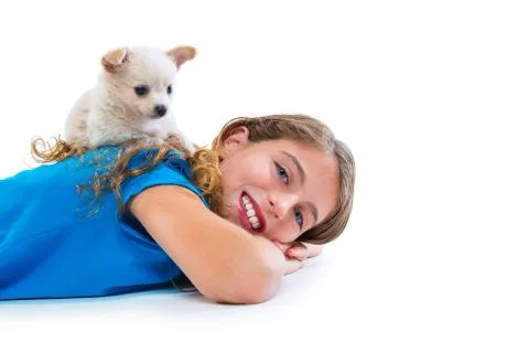 Puppy chihuahua dog on kid girl lying happy smiling Stock Photos