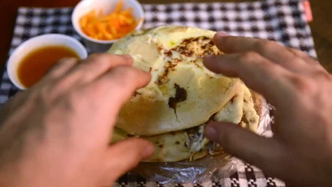 Pupusas dish with hands cutting open el salvador central america Stock-Footage 129581921