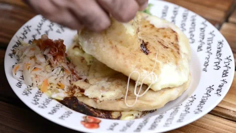Pupusas dish with hands cutting open el salvador central america Видео 147910431