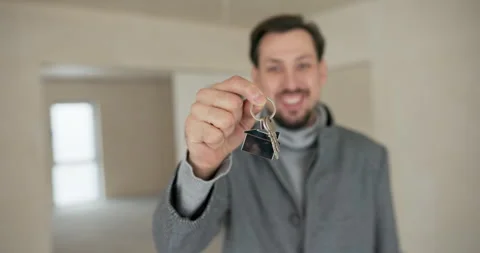 Purchase of an apartment, house from a developer. Smiling cheerful man looks Stock Footage 260687704
