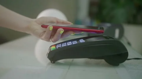 Purchase by cell-phone on electronic payment machine or card reader. E-money at Video stock 150051282