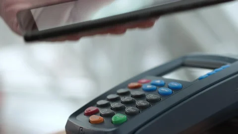 Purchase by cell-phone on electronic payment machine or card reader of store. E- Video stock 199480643