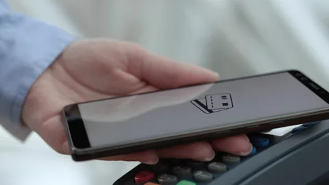Purchase by cell-phone on electronic payment machine or card reader of store. E- Stock Footage 199480671