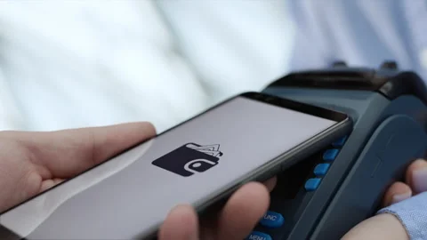 Purchase by cell-phone on electronic payment machine or card reader of supermark Stock Footage 199480676