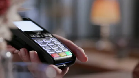 Purchase by cell-phone on electronic payment machine or card reader. E-money at Stock Footage 199480820