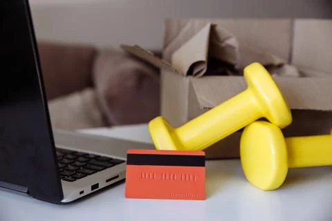 Purchase of sporting goods in an online store with delivery. Stock Photos
