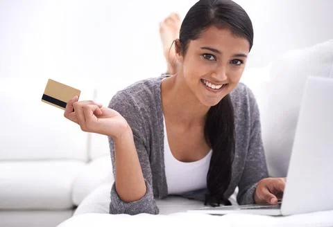 Purchasing online has never been easier. A beautiful young woman using her Stock Photos