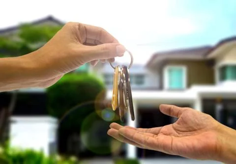 Purchasing  property with two hands and key Stock Photos