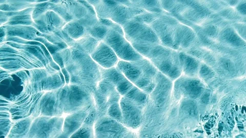 Pure blue water with light reflections. Swimming pool water surface from above. Stock Footage 164729800