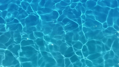 Pure blue water in the pool with light reflections. Slow motion. Stock Footage