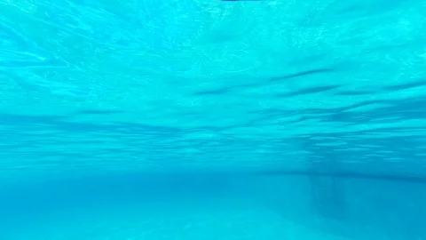 Pure blue water in the pool with light reflections. View from under water on Video stock 112664682