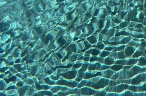 Pure blue water in the pool with light reflections. Slow motion. HD Stock Footage 231752528
