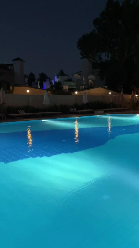 Pure blue water in the pool with light reflections. Slow motion. Vertical Stock Footage 346720115