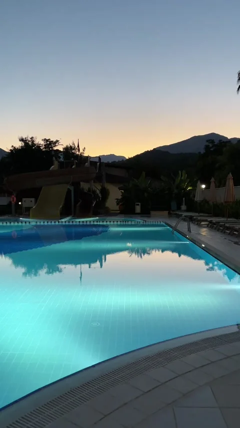 Pure blue water in the pool with light reflections. Slow motion. Vertical Stock Footage 346720172
