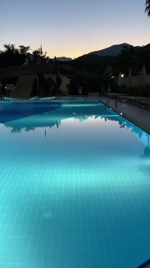 Pure blue water in the pool with light reflections. Slow motion. Vertical Stock Footage 346720183