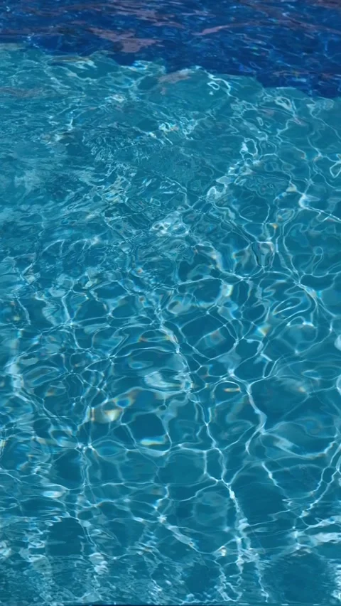 Pure blue water in the pool with light reflections. Slow motion. Vertical Stock Footage 346720670