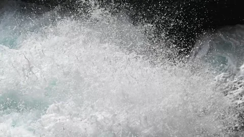 Pure bright turquoise waves break into white foam on the coastal cliffs and Video stock 259538631