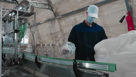 Pure drinking water plant. Work conveyor in the enterprise Stock Footage 130876243