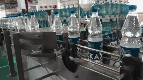 Pure drinking water plant. Work conveyor in the enterprise Stock Footage 130879447
