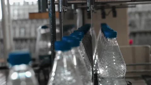 Pure drinking water plant. Work conveyor in the enterprise Stock Footage 130879559