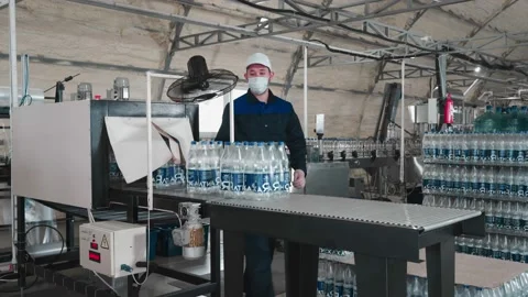 Pure drinking water plant. Work conveyor in the enterprise Stock Footage 130879684