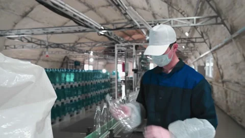 Pure drinking water plant. Work conveyor in the enterprise Stock Footage 130879907