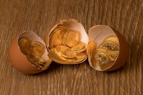 Pure gold coins in egg shell illustrating nest egg Selection of pure gold ... Stock Photos
