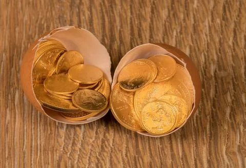 Pure gold coins in egg shell illustrating nest egg Selection of pure gold ... Stock Photos