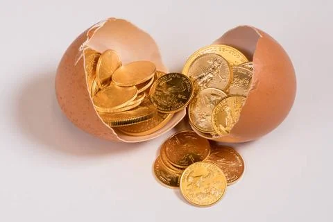 Pure gold coins in egg shell illustrating nest egg Selection of pure gold ... Stock Photos