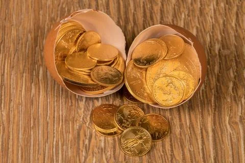 Pure gold coins in egg shell illustrating nest egg Selection of pure gold ... Stock Photos