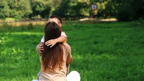 Pure maternal affection. Young boy running to mother to hug tightly. Authentic Stock Footage 318300489