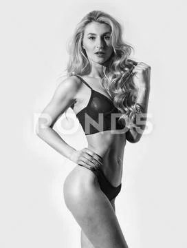 Pure perfection. Fashion model with fit belly. Sexy woman with long curly hair Stock Photos