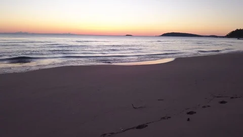 Pure sandy beach and reflective water at sunrise Stock Footage 100134632