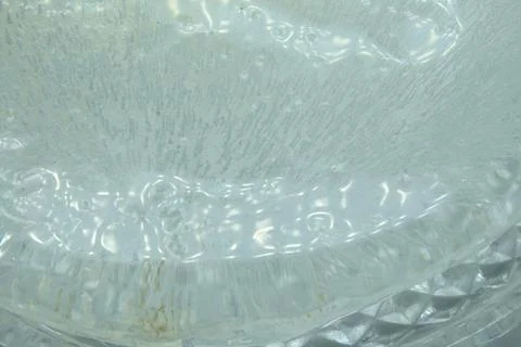 Pure transparent rectangular ice block with air bubbles on purpure background Stock Photos