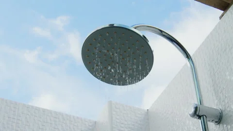Pure water droplets flow from the shower head with sky background Stock-Footage 341916861