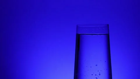 Pure Water Elegance on Blue Gradient Stock Footage 256763791