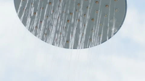 Pure water flow from the shower head with sky background Stockbeeldmateriaal 341917080