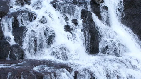 Pure water stream running through stone boulders, Wild mountain river splash 8k Stock Footage 235463400