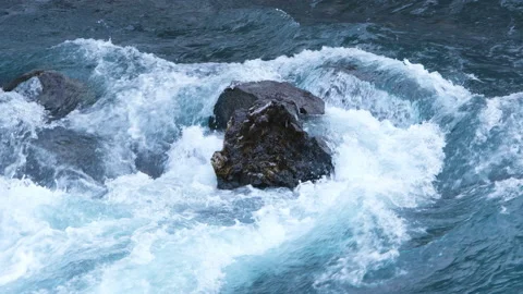 Pure water stream running through stone boulders, Wild mountain river splash 8k Stock Footage 235466184