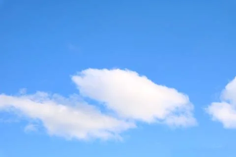 Pure White Fluffy Clouds Floating on Vibrant Blue Sky 스톡 사진