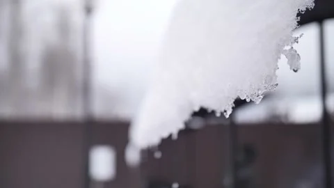Pure white snow hangs on the eaves of the house. Stock Footage 229556285