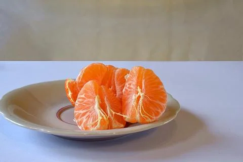 Purified mandarin on the light surface of the table. Stock Photos