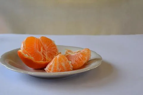 Purified mandarin on the light surface of the table. Stock Photos