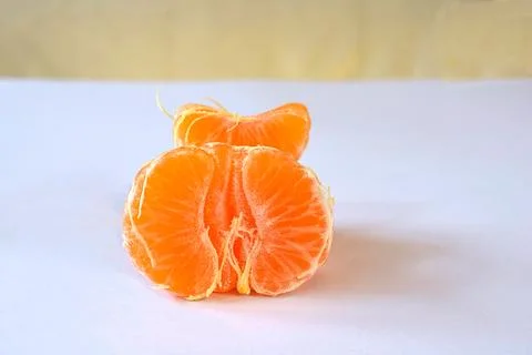 Purified mandarin on the light surface of the table. Stock Photos