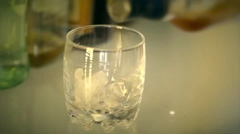 Puring alcoholic drink into glass Stock Footage 61380338